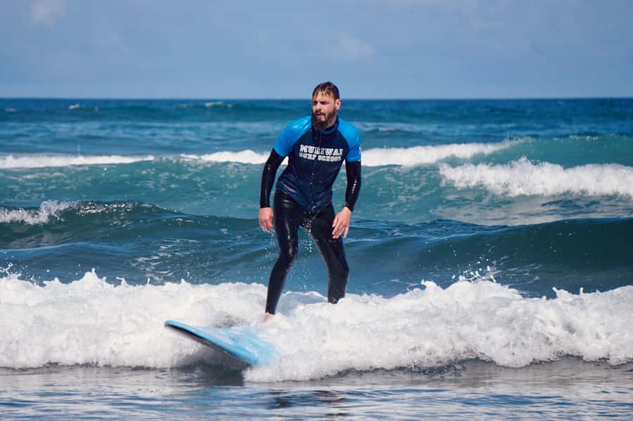 Auckland: Group Surfing Lesson with Muriwai Surf School - Your 2-hour flow: equipment basics to catching waves