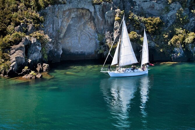 Lake Taupō Private Day Tour from Auckland to Māori Rock Carvings - The Mine Bay Māori Rock Carvings cruise on an electric yacht
